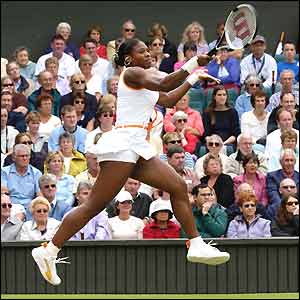 Serena Williams jumps in the air as she plays a shot