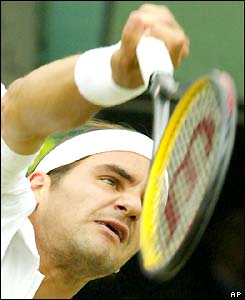 Roger Federer serves