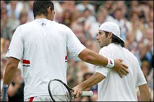 Both players shake at the net as Mark Philippoussis beats Sebastien Grosjean 