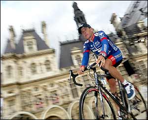 Lance Armstrong rides past the town hall in Paris during the presentation of the riders ahead of the 100th Tour de France