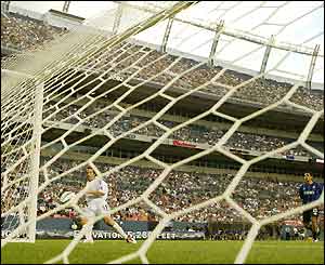 Kansas City Wizards striker Robert Preki slots the ball into an empty net to score against the Colorado Rapids