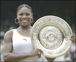 Serena Williams holds the ladies' singles winners' trophy, the Venus Rosewater Dish