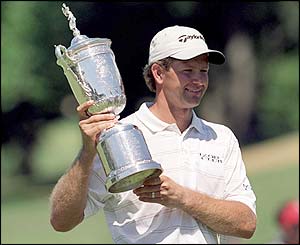 Retief Goosen lifts the trophy after winning the title in 2001