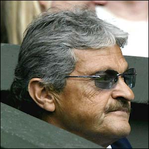 Nick Philippoussis, Mark's father and coach, watches from the players' box