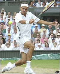 Roger Federer reaches to play a backhand