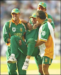 South Africa players and the physio carry the injured Nicky Boje from the field