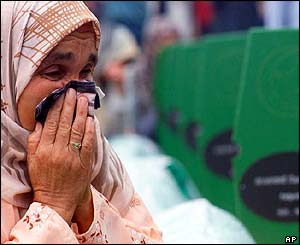 Hura Hrnjic, 60, weeps at the grave of her husband Meho