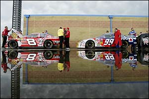 Crew members push their cars through inspection at the NASCAR Winston Cup