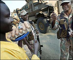 A Bujumbura egg vendor gets a thumbs up from a South African soldier