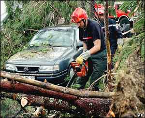 Firefighters clear fallen trees at the La Rive campground near Biscarosse