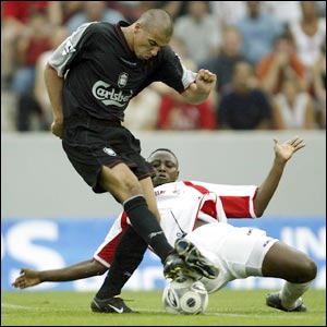 Milan Baros takes on a Cologne defender