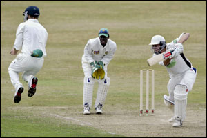 Somerset's Carl Gazzard drives the ball at Boerta Dippenaar of South Africa 