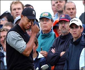 A disappointed Tiger Woods pulls his cap over his eyes