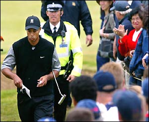 Tiger Woods is hotly pursued by a policeman
