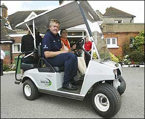 Colin Montgomerie drives from the course on a buggy