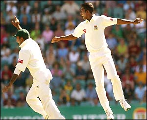 Bangladesh bowler Tapash Baisya (right) is airborne as he celebrates the wicket with teammate Habibul Bashar, left, after dismissing Australian batsman Ricky Ponting for 10 runs