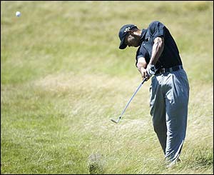 Tiger Woods plays a shot on the first