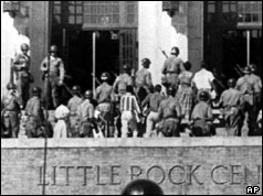 Troops escort nine black students into Central High School in Little Rock 