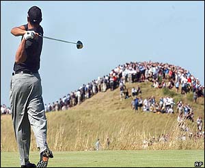 Woods plays a shot on the fifth