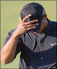 Tiger Woods bows his head at the eighteenth green