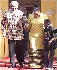 Nelson Mandela and his wife appear from their Johannesburg home
