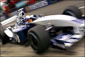 Juan Pablo Montoya drives away from the pits