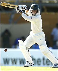 Justin Langer drives at the ball