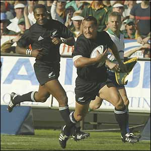 New Zealand's Carlos Spencer sprints clear to score the opening try of the match