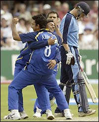 Surrey's Azhar Mahmood celebrates taking the wicket of Gloucestershire's Ian Harvey