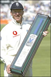Alec Stewart accepts a trophy before play on day one at The Oval