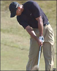 Tiger Woods plays an iron shot