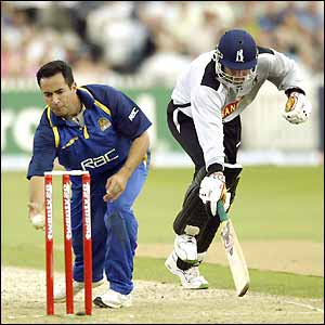 Surrey captain Adam Hollioake runs out Neil Smith to end the Warwickshire innings