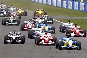 Jarno Trulli gets ahead of Rubens Barrichello going into the first corner