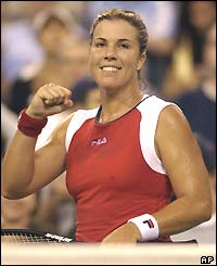 Jennifer Capriati smiles and clenches her fist to celebrates reaching the last four
