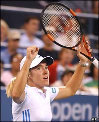 Justine Henin-Hardenne raises her arms to the crowd after reaching the semi-finals
