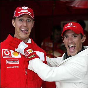 Ferrari star Michael Schumacher and jockey Frankie Dettori share a laugh at the British Grand Prix at Silverstone