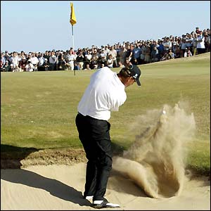 Thomas Bjorn struggles in a bunker at the 16th hole at Sandwich, carding a triple bogey that costs him victory at the Open
