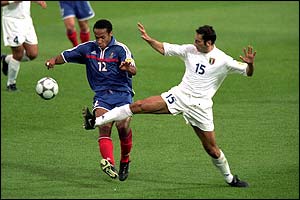 Thierry Henry and Italy's Mark Luliano fight for the ball
