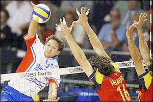 France's Frantz Granvorka hits the ball against Spain's Juan Jose Salvador and Cosme Prenafeta, during their 2003 European Volleyball Championship preliminary match