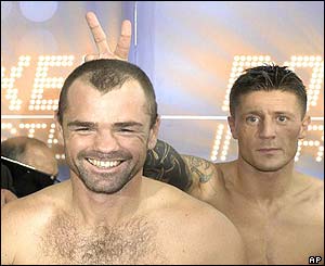 Challenger Mads Larsen from Denmark jokes behind the back of Germany's boxer Sven Ottke