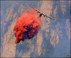 Plane drops fire-retardant chemicals in Gravone valley, Corsica