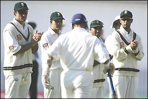England's Alec Stewart gives the South African players a thumbs up to acknowledge them lining up as he comes to the crease