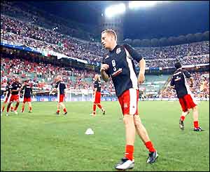 Craig Bellamy warms up with his Welsh team-mates in the San Siro