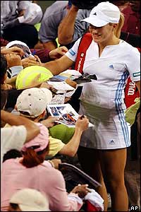 Henin-Hardenne signs autographs on her way out of the Arthur Ashe Stadium