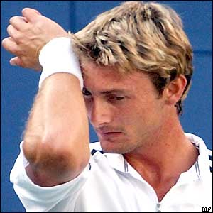 Juan Carlos Ferrero wipes his brow in disappointment