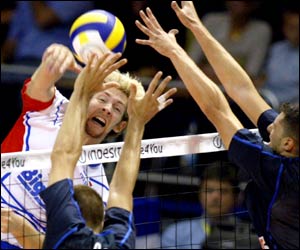 France's Stephane Antiga tries to spike the ball past Italy's defence during their match at the European Volleyball Championships