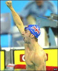 James Gibson of Great Britain punches the air after winning the 50m breaststroke gold medal