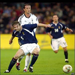 Scotland's Steven Pressley challenges Bobic for the ball