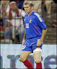 France's Zinedine Zidane holds his injured thigh