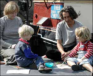 Finn joins his friend Oscar painting on the top of his boat
